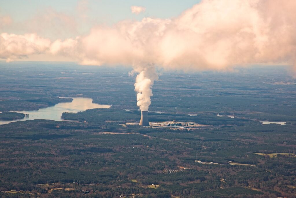 an aerial view of a coal plant with smoke coming out of it