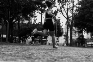 woman running in city park black and white shot